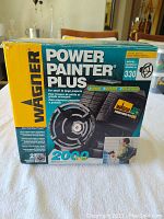 Front view of the Wagner Power Painter Plus Model 330 boxed product showing branding and specifications.
