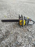 McCulloch PowerMAC 18 inch chainsaw laying on gravel ground
