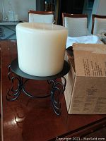 3-wick white pillar candle on black metal decorative stand