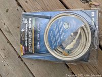 Front view of Monster Cable HDMI cable in original unopened packaging showing the cable coiled inside and product title on card insert.