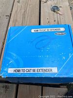 Closed blue packaging box labeled 'HDMI TO CAT5E EXTENDER'