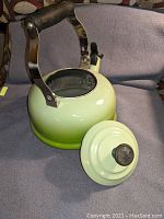 Le Creuset kettle with lid removed showing interior and black handle.