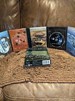 Five-disc Planet Earth DVD set displayed open showing discs and cover box.