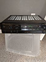 Front and top view of Nakamichi TA-2A stereo amplifier showing control panel and ventilation grilles.