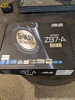 Box showing ASUS Z97-A motherboard with 5-Way Optimization, USB 3.1, Windows 10 compatibility and connectivity features.