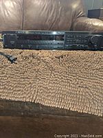 Front view of Carver CT-17 preamplifier tuner showing power button, digital display, memory buttons and EQ controls