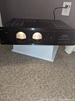 Front view showing dual lit VU meters and chassis condition