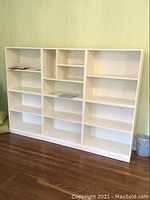 Three bookcase modules assembled side by side, showing full front view