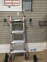 Ladder in partially extended A-frame position leaning against slatwall