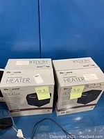Photo showing two boxed Life Zone Quartz Infrared Heaters next to each other with labels 33 and 34 visible.