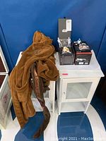 Overall lot on small white cabinet showing BB-8 package, clone troopers, and robe draped