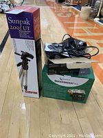 Photo showing Sunpak 200I UT tripod box alongside the boxes for ClearClick Quick Convert 2.0 and Sony camcorder with cables on top