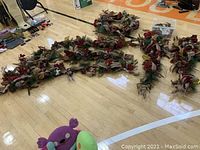 Multiple garland sections and wreath laid out on gym floor