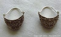 Pair of vintage Sajen sterling silver earrings with scroll and bead decoration, shown on white cloth background.