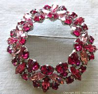 Top-down view capturing circular wreath shape and multicolored pink crystals layout.