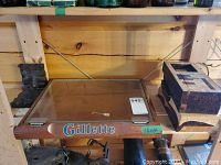 Wooden Gillette counter display case on shelf
