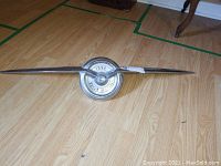 Full front view of grille ornament on wood floor