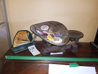 Champion scale with pin back buttons on metal tray, Jiffy Way egg scale with dial visible, set on wooden surface.