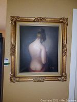 Frontal view of the oil painting showing the entire artwork including ornate gold frame and subject facing away with bare back.