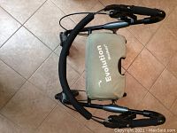 Folded Evolution walker showing seat cover and frame.