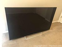 Front view of Sony Bravia 46" TV on carpeted floor