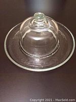 Clear glass appetizer platter with dome cover, photographed to show the serving piece and lid.