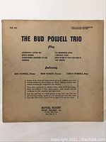 Front of record sleeve showing track listing and artist credits.