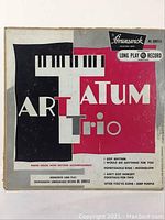 Front of the Brunswick BL-58013 record sleeve featuring Art Tatum Trio album cover design with piano keyboard graphic and artist title.
