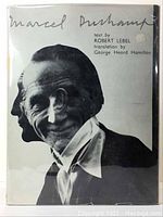 Front cover of Marcel Duchamp book showing black and white dual profile photo and title.