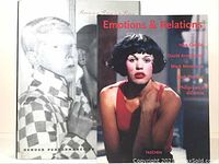 Two photography art books displayed with covers visible, showing titles and photographic portraits relevant to book content.