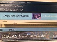 Close-up of book spines showing titles related to Edgar Degas artwork and collections from various publishers