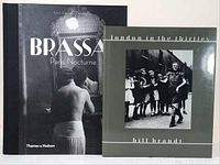 Photo showing two hardcover photography art books side by side: 'Brassai Paris Nocturne' and 'London in the Thirties' by Bill Brandt.