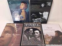 Photo showing five Criterion Collection DVD movies titled Magnificent Obsession, Dames Bois de Boulogne, The River, Pedro Páramo, and A Room with a View arranged side by side.