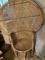 Front view showing full high rounded back and circular seat