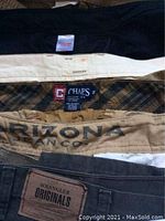 Photo of waistbands showing six pairs of men's casual shorts from Chaps, Dockers, Wrangler, Arizona Jean Co.