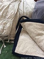 Photo showing the light blue Pottery Barn duvet cover with down insert and edge details with drawstring ties.