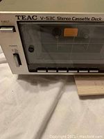 Front left portion showing TEAC V-53C label, power switch, eject button, control buttons and cassette window.