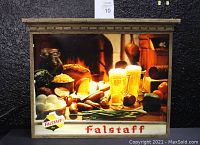 Front view of the rectangular Falstaff Beer lighted sign featuring food items and two glasses of beer in a warm fireplace setting, housed in a wooden frame.