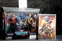 Two-pack Marvel Legends action figures of Star-Lord and Marvel's Ego in original packaging with accessories and exchangeable heads, next to a Guardians movie DVD case.