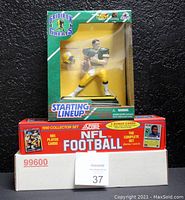 Photo showing the NPC container box with the 1990 Score NFL Football Cards Complete Set and Brett Favre figurine in original packaging.