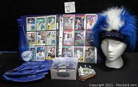 Full lot showing binder of baseball cards, baseball glove, fuzzy head cap on mannequin, Dodgers water bottle, and stadium replica box
