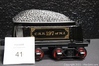 Side view of the black and silver ceramic Coal Car with C.R.R. 197 of N.J. gold lettering and red wheels.
