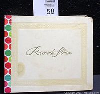 Photo of the vintage off-white binder labeled 'Records Album'.