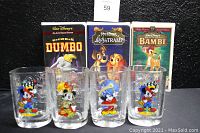 Photo showing front of VHS boxes for Dumbo 60th, Lady and the Tramp, and Bambi 55th Anniversary editions with the four square Disney glasses depicting Mickey Mouse characters in front.
