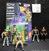 Front view of all five Aliens action figures with sealed Space Marine Corp Hicks figure in original packaging and four loose figures in front