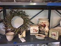 Full view of the bathroom ceramic collection displayed on a shelf showing all items including the wreath.