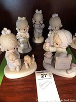 Image showing five Precious Moments figurines including girl with bowl, child with puppy, and other children figurines