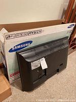 Back view of the Samsung LED TV showing the rear connections and venting along with original Samsung box.