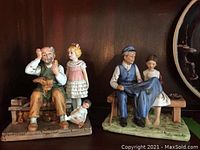 Photo showing both Norman Rockwell figurines on a dark shelf background, highlighting the full scene of each piece.