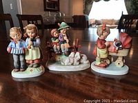 Photo showing all three Goebel figurines on table